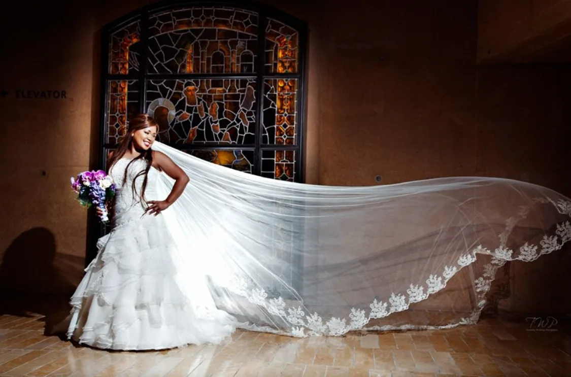 Bride in a long lace veil styled by Cherry's Salon